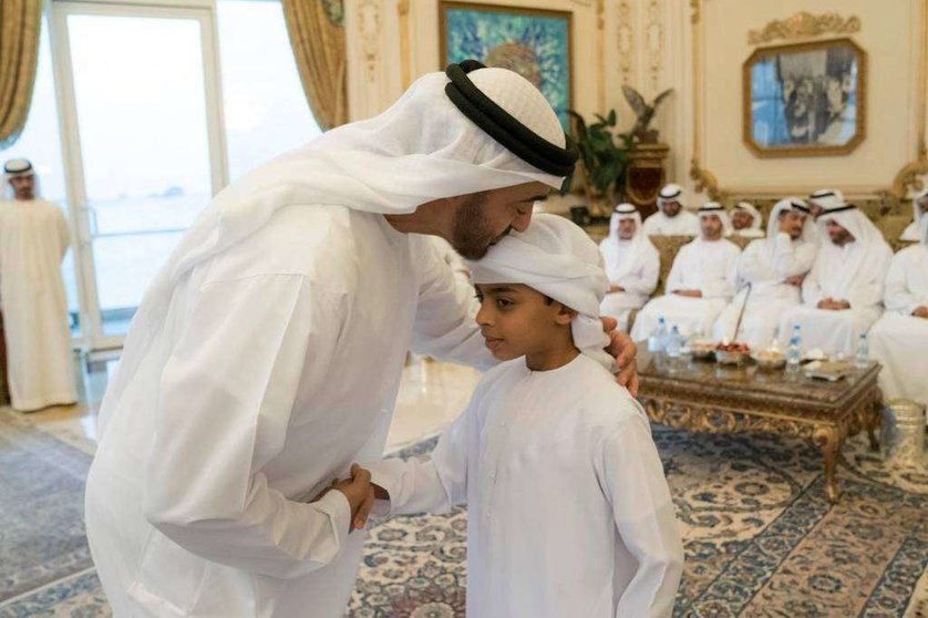 El príncipe heredero de Abu Dhabi junto a uno de los hijos de los héroes caídos.