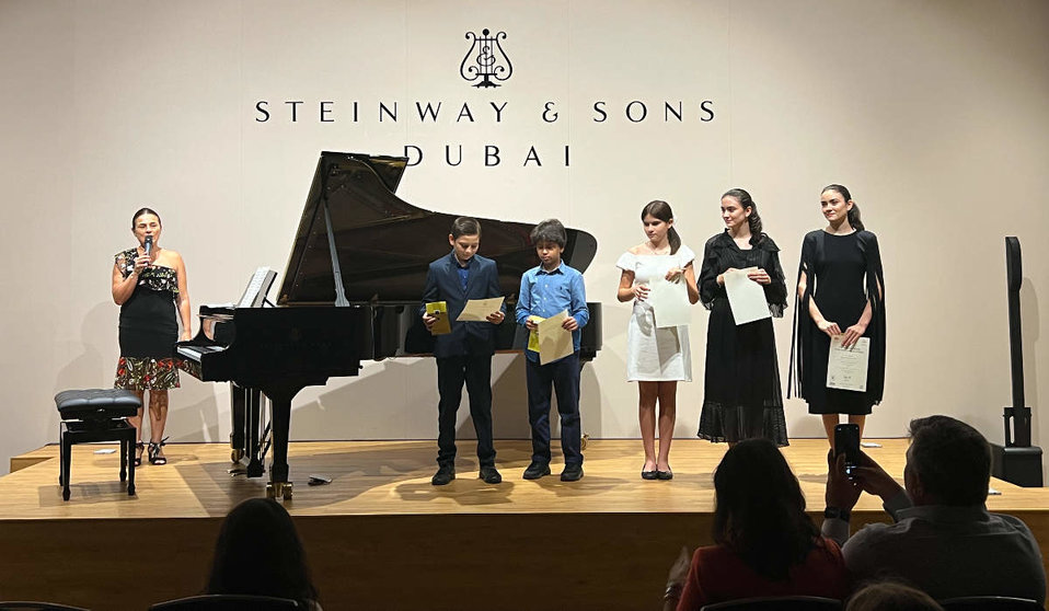 María del Rosario Sierra, junto a sus alumnos sobre el escenario de House of Pianos Al Qouz en Dubai. (EL CORREO)