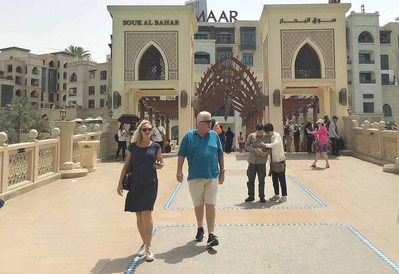 Turistas en el puente que da acceso a Souk Al Bahar en la plaza de Fuente de Dubai. (EL CORREO)