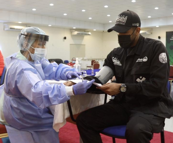 Un policía de EAU recibe una dosis de la vacuna. (WAM)